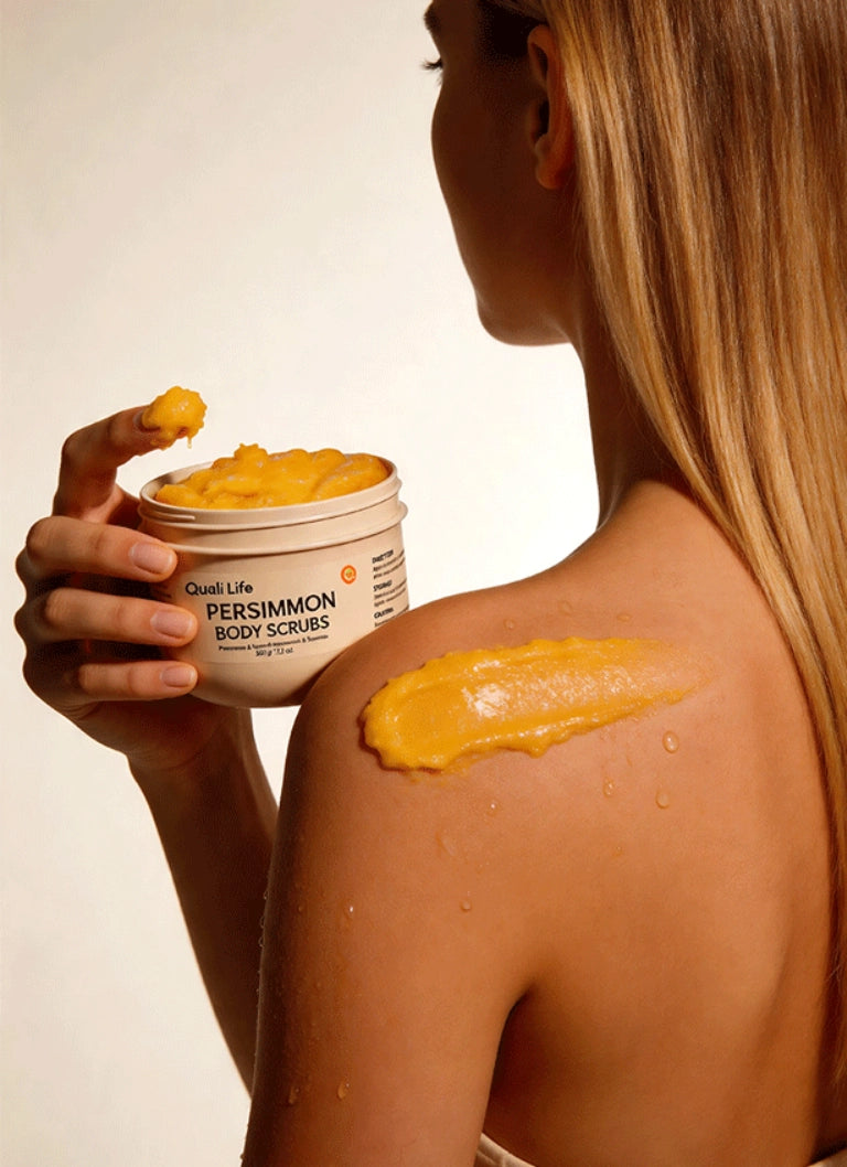 woman_applying_qualilife_persimmon_body_scrub