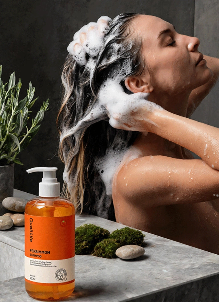 woman_using_qualilife_persimmon_shampoo